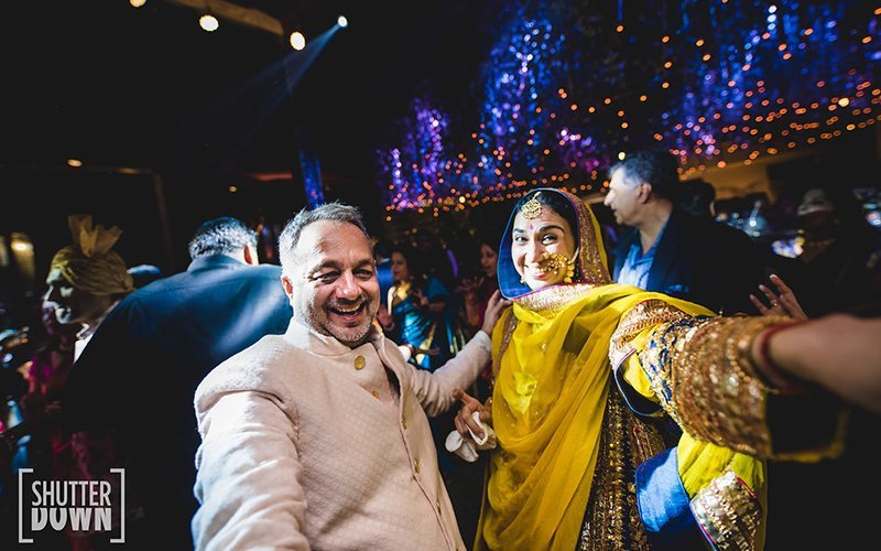 Bride dancing with In laws, in a Indian Wedding